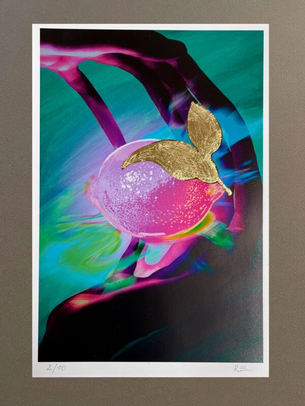 Hands and a vibrant lemon art print with gold leaf